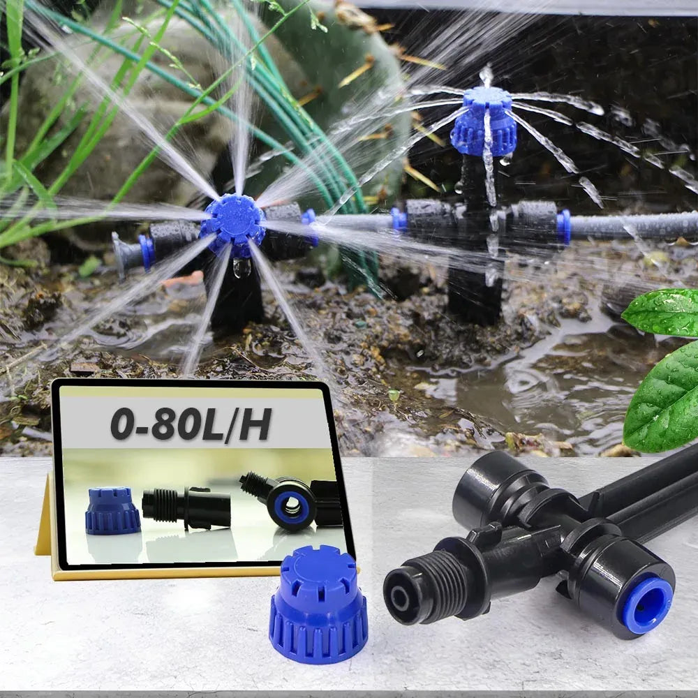 Outdoor drip sprayer with blue sprinkler heads spraying water over garden soil