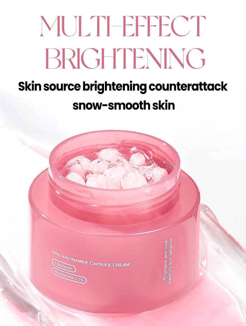 Open jar of pink Niacinamide capsule cream with visible pink spheres in a clear gel base against a white background.