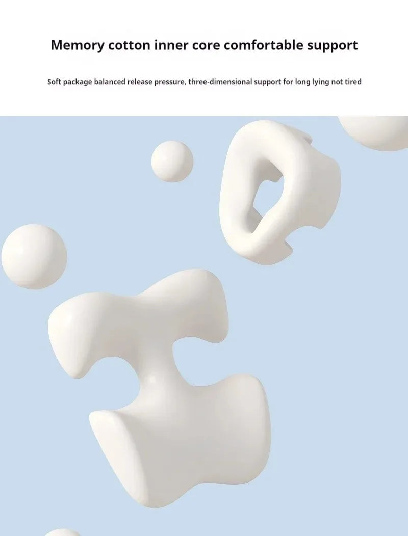 White, ergonomic memory foam salon massage cushions shaped for face and breast support floating on a blue background.