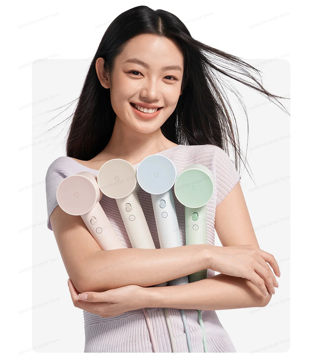 Woman holding four colorful, compact MIJIA high-speed hair dryers with powerful airflow and sleek, ergonomic design.