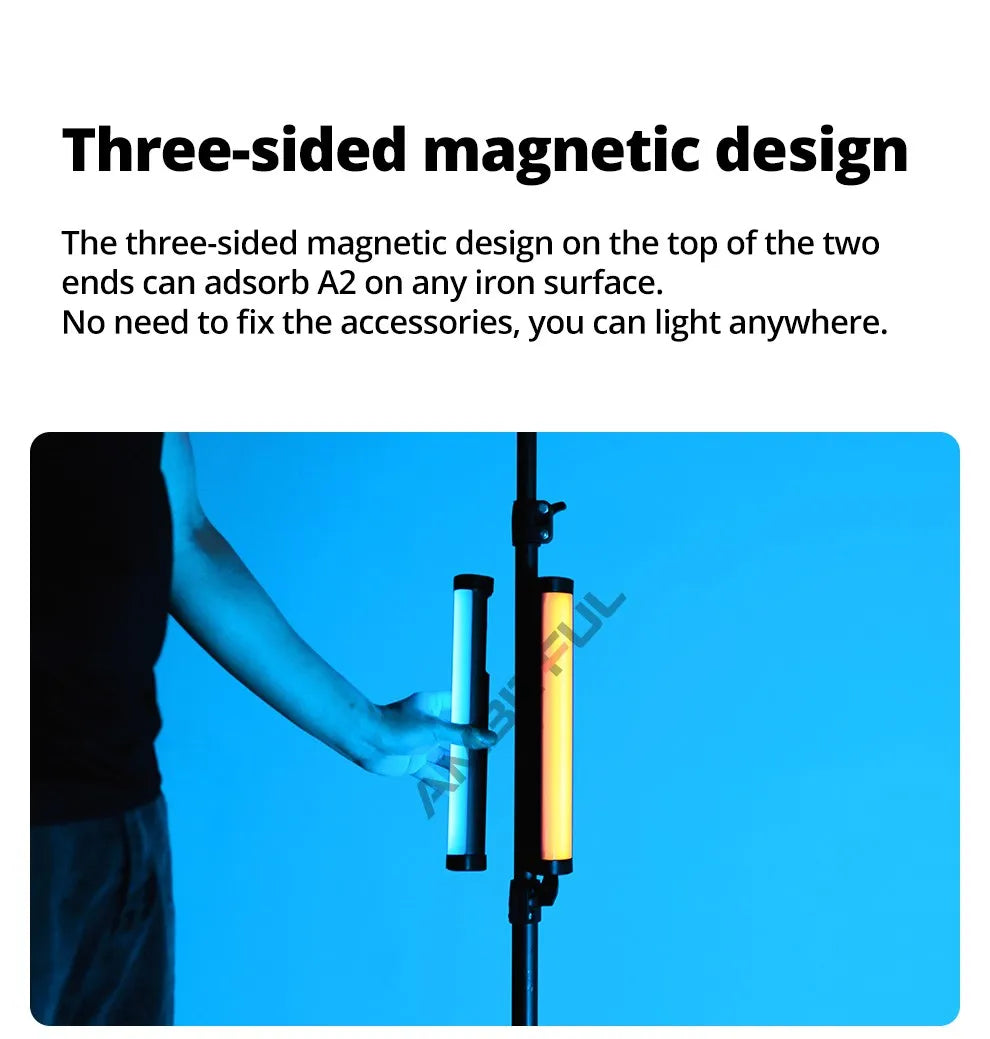 Magnetic LED light tube attaching to a metal stand, emitting white and warm light for portable lighting setups.