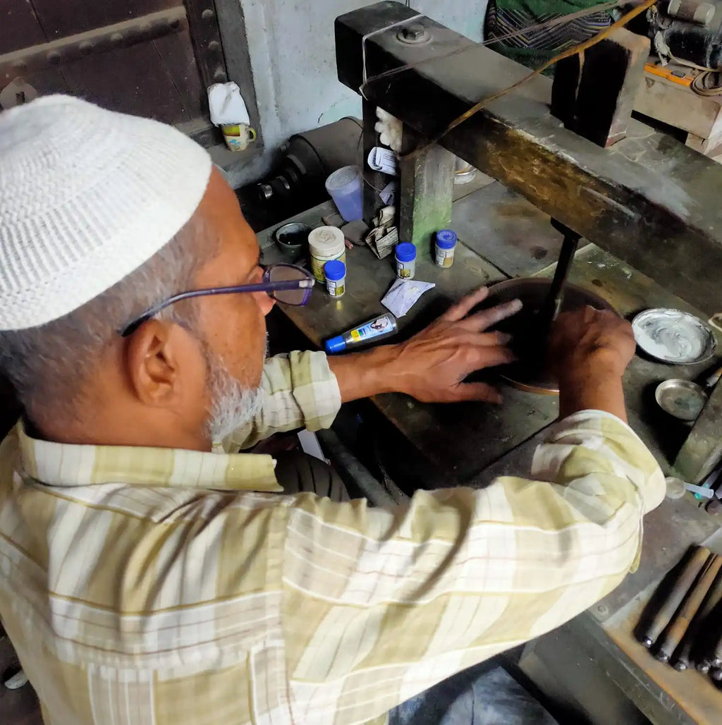 Jewelers hands working at a workbench with gemstone tools