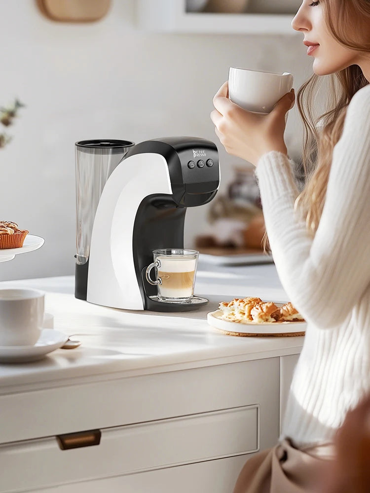 Bene Presso black and white compact single-serve espresso coffee maker brewing in a modern kitchen.