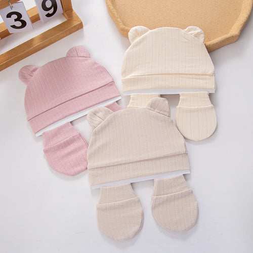 Tidesmit baby sets in pink and beige ribbed cotton, featuring beanies with cute bear ears and matching mittens.