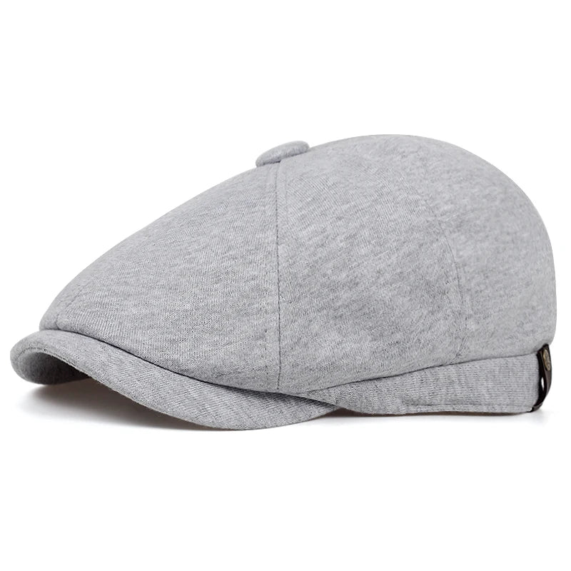 Side view of a Tidesmit light grey cotton ivy cap, featuring a classic flat-top shape and a stiff, curved brim.