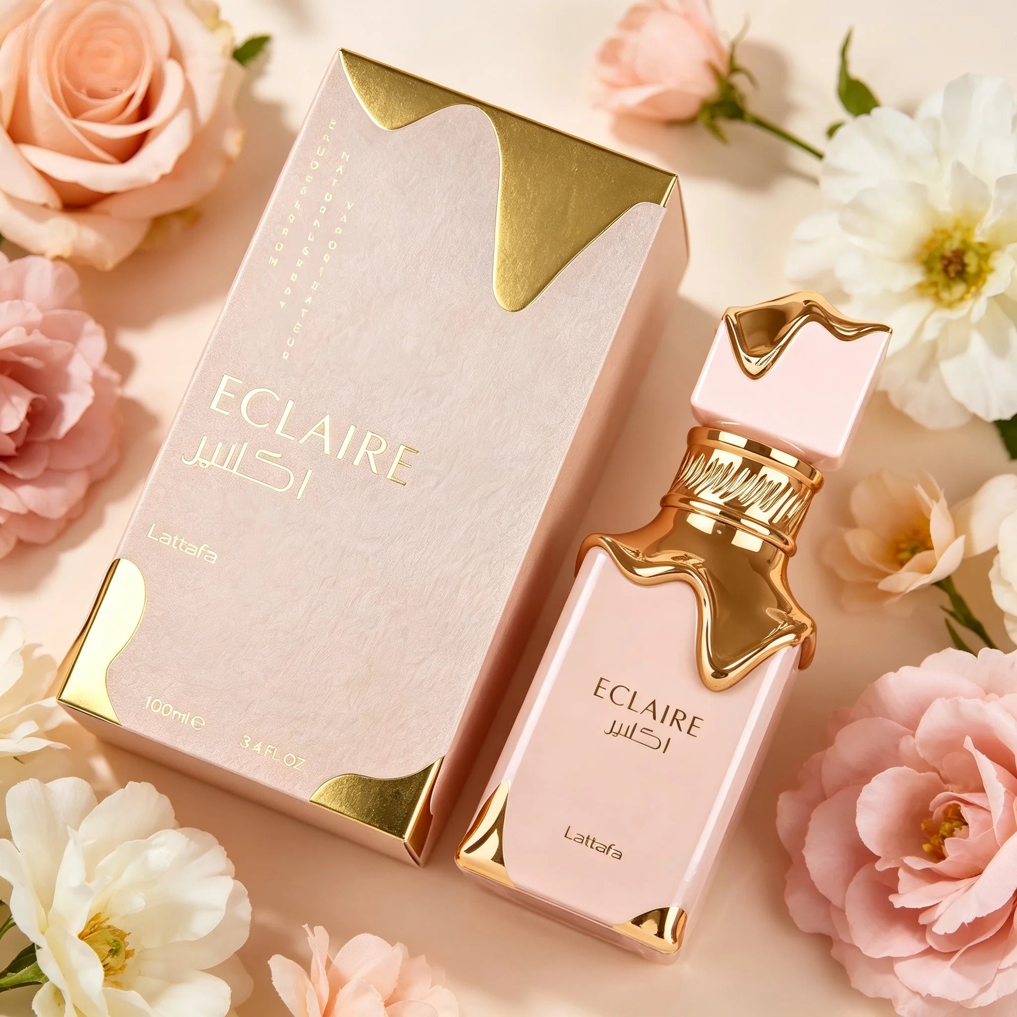 Lattafa Eclaire perfume bottle and box in soft pink and gold with floral accents, 3.4 oz gourmand fragrance.