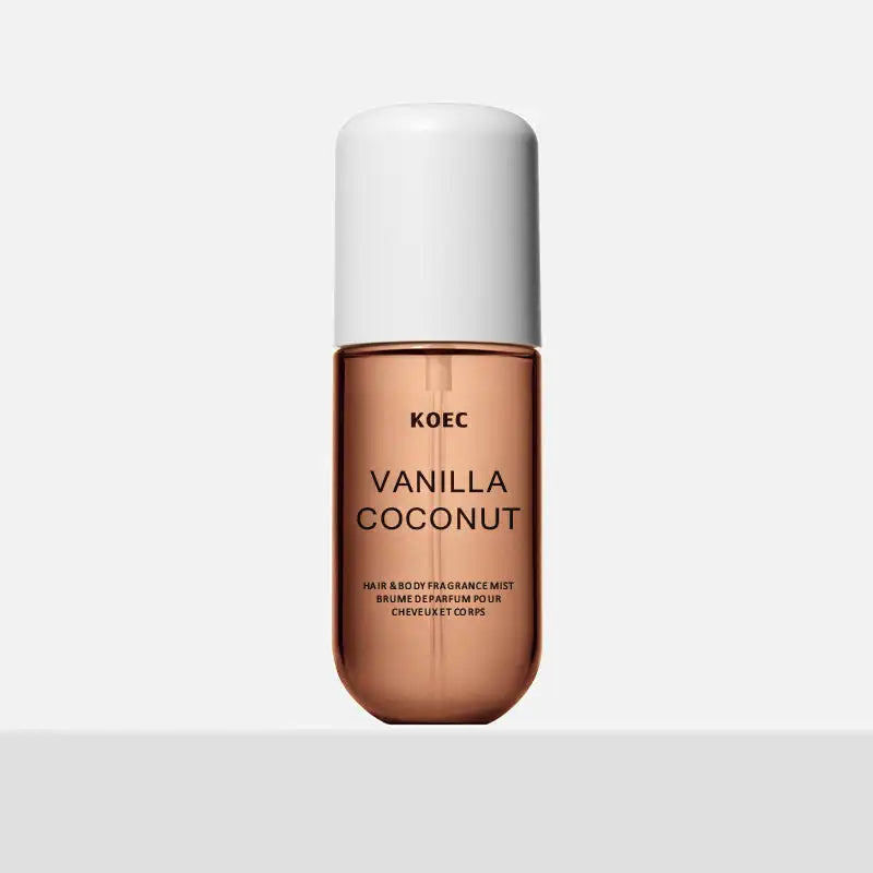 KOEC Vanilla & Coconut hair and body fragrance mist in a sleek, cylindrical glass bottle with a white cap.