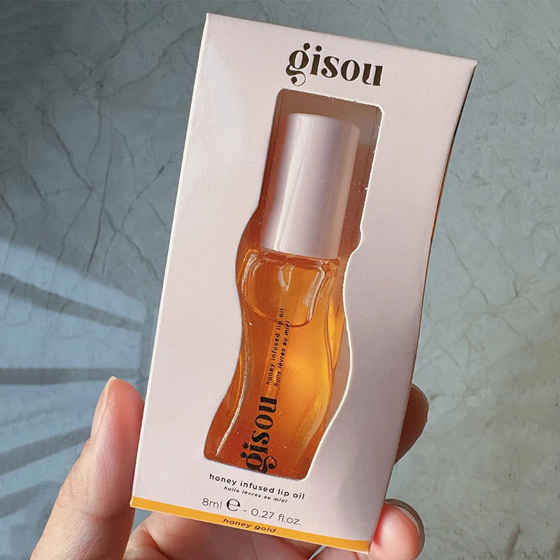 Gisou Honey Infused Lip Oil in Honey Gold: a hydrating, glossy golden lip treatment in its original packaging.