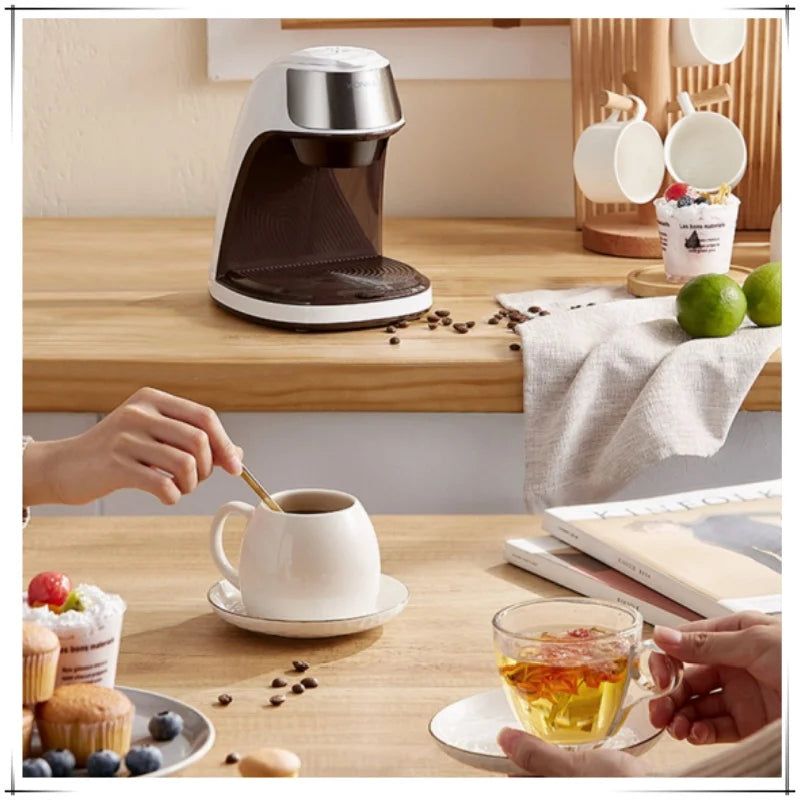 VonShef compact white and stainless steel single-serve coffee maker on a wooden kitchen table.