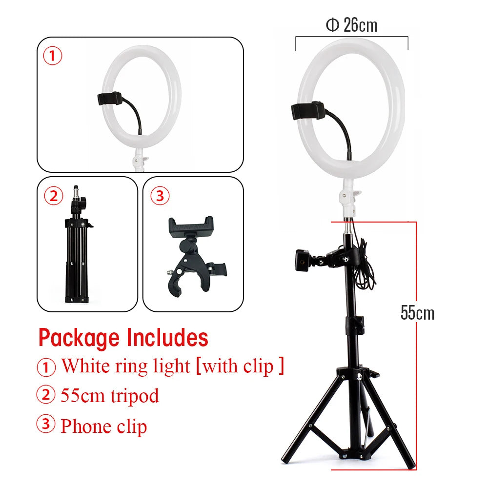 26cm ring light on a 55cm black metal tripod stand with an adjustable phone clip for photography and video recording.