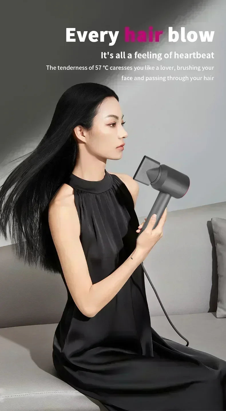 Woman using a sleek grey ionic hair dryer with styling nozzle for professional salon-quality blowouts at home.