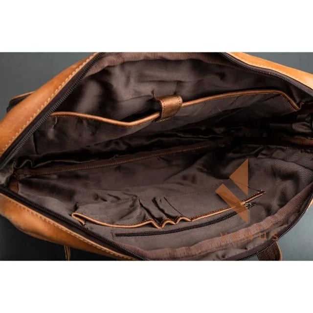 Tan genuine leather business briefcase interior with brown fabric lining, organizer pockets, and laptop compartment.