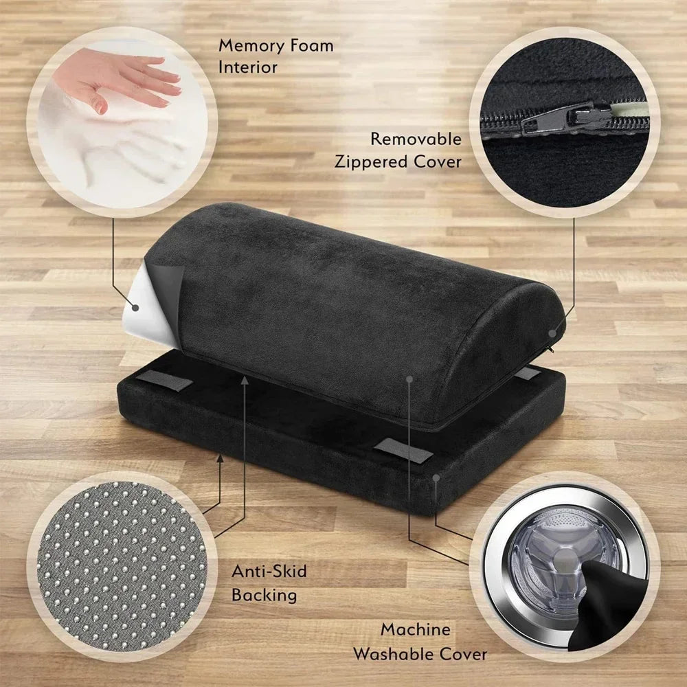 Black ergonomic under desk footrest with memory foam, anti-skid base, and removable machine-washable zippered cover.
