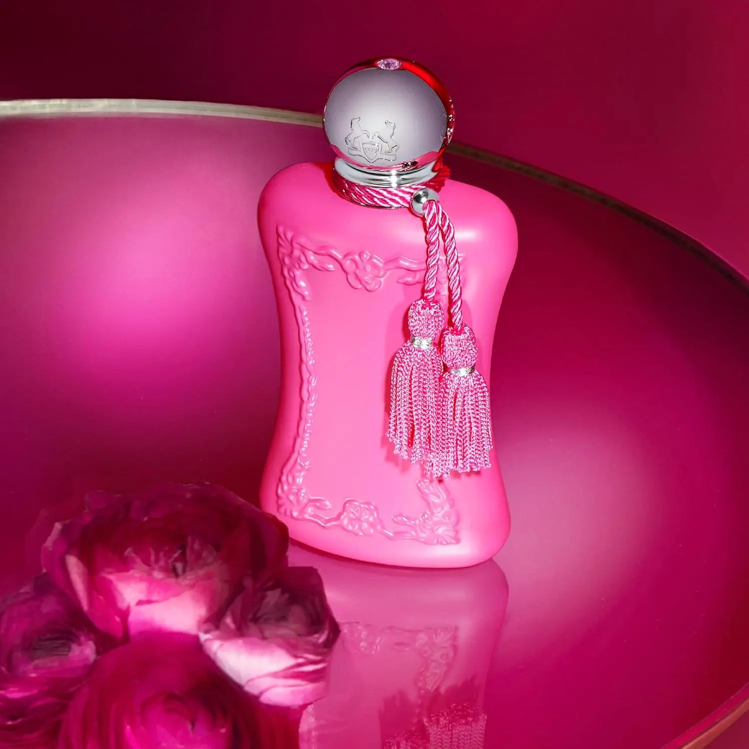 Parfums de Marly Delina Eau de Parfum for women: pink floral fragrance in an elegant tasseled bottle on magenta surface.