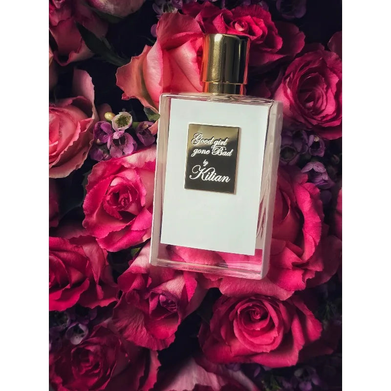 Kilian Good Girl Gone Bad EDP 50ml: rectangular unisex floral perfume bottle set against dark pink roses.