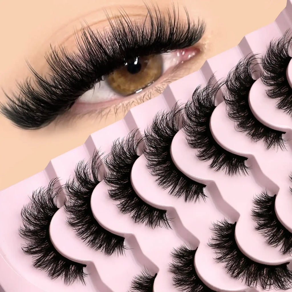 Fluffy, black 3D mink cat-eye false lashes on a pink tray, shown applied to an eye for a wispy, feathery effect.