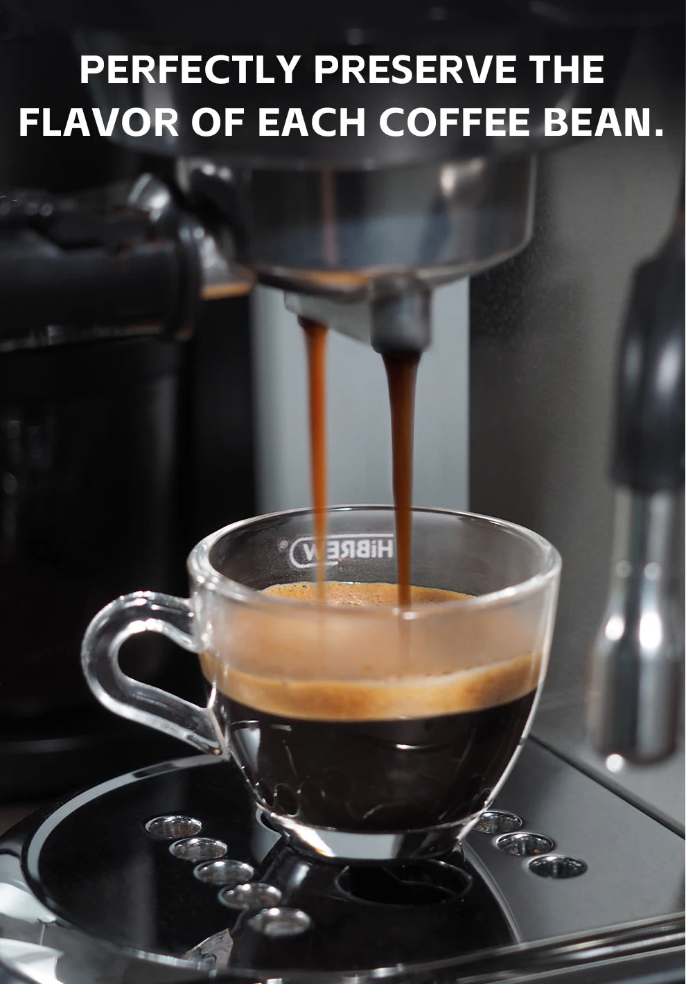 Hibrew espresso machine pouring fresh coffee into a small glass cup on a modern black and silver coffee maker base.