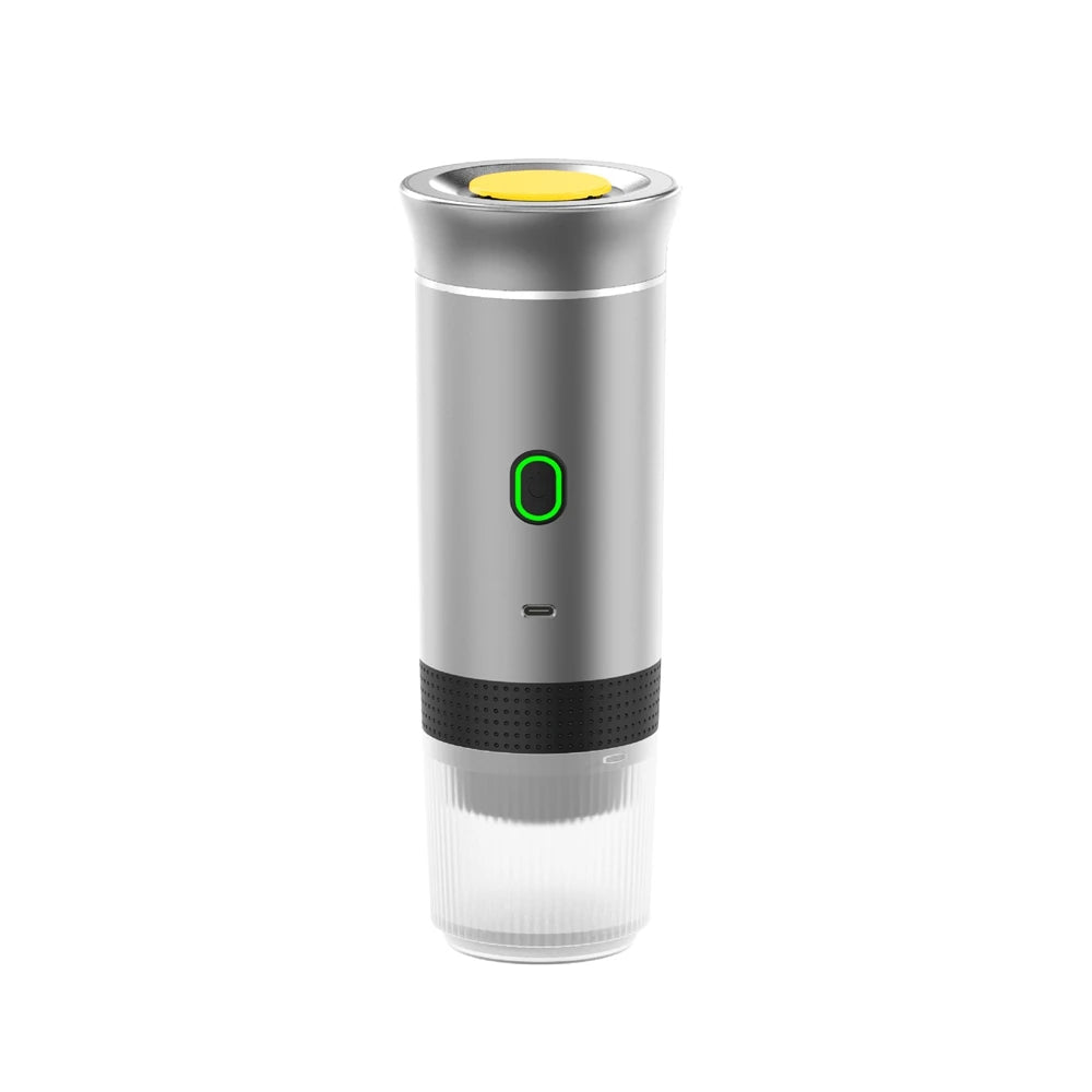 Portable silver electric espresso maker with yellow top button, green power light, and clear base cup.