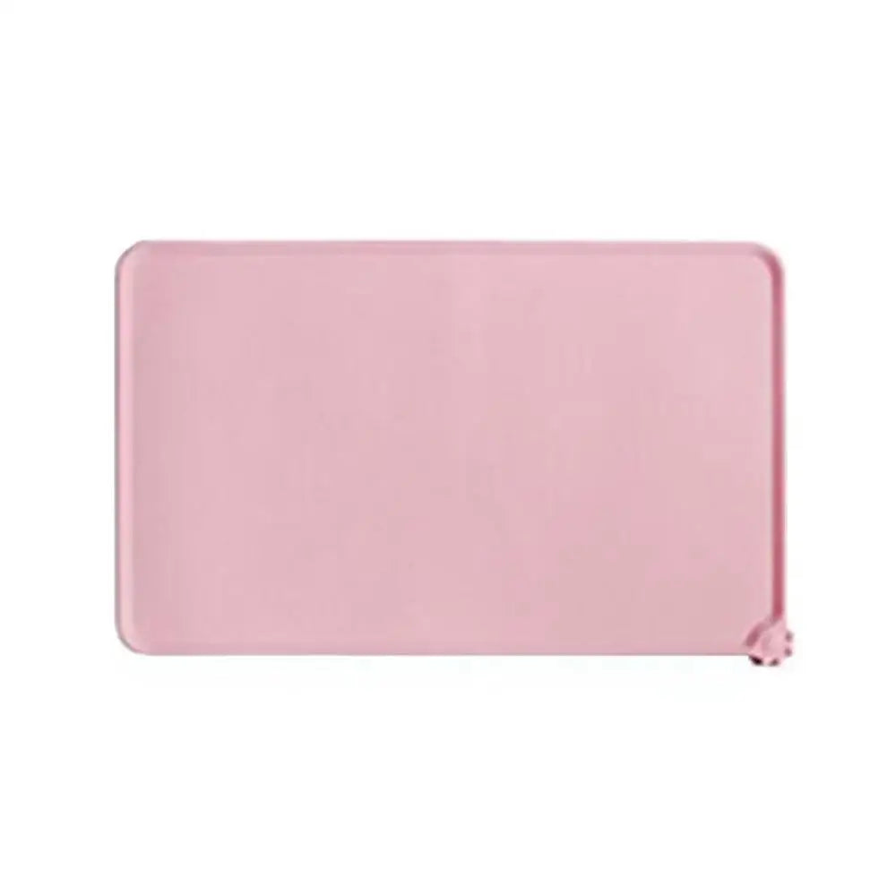 Pink waterproof silicone pet feeding mat with raised edges to prevent spills. BPA-free food-grade dog and cat bowl mat.