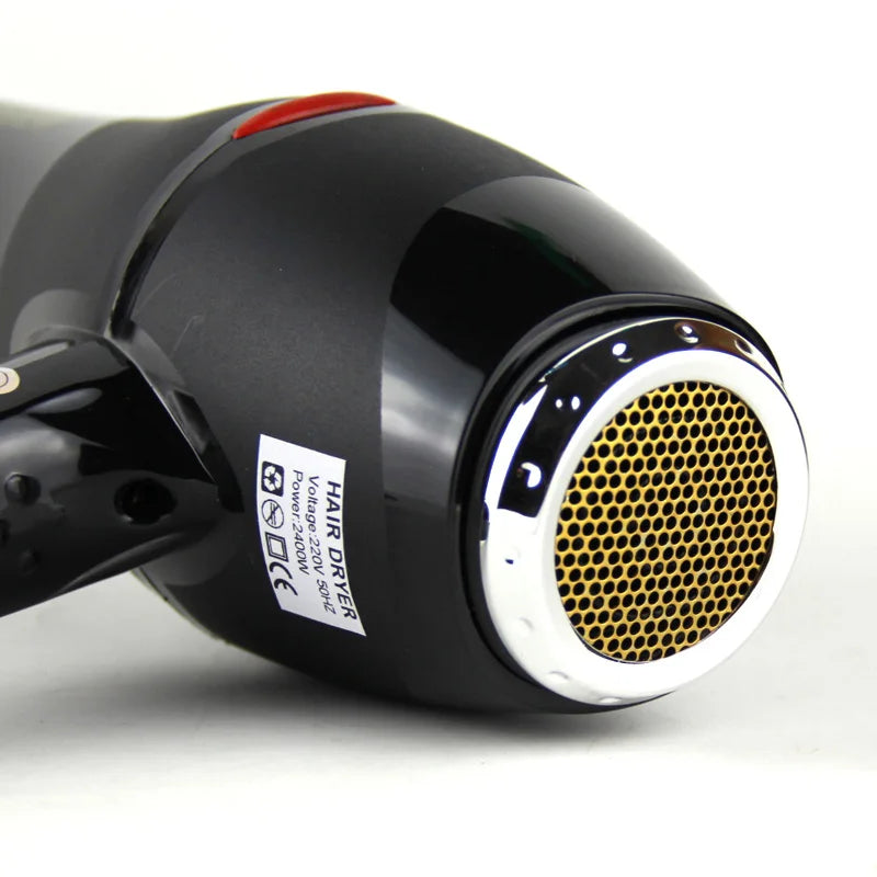 Black professional hair dryer with gold rear intake grill and high-power AC motor for fast salon-quality drying.