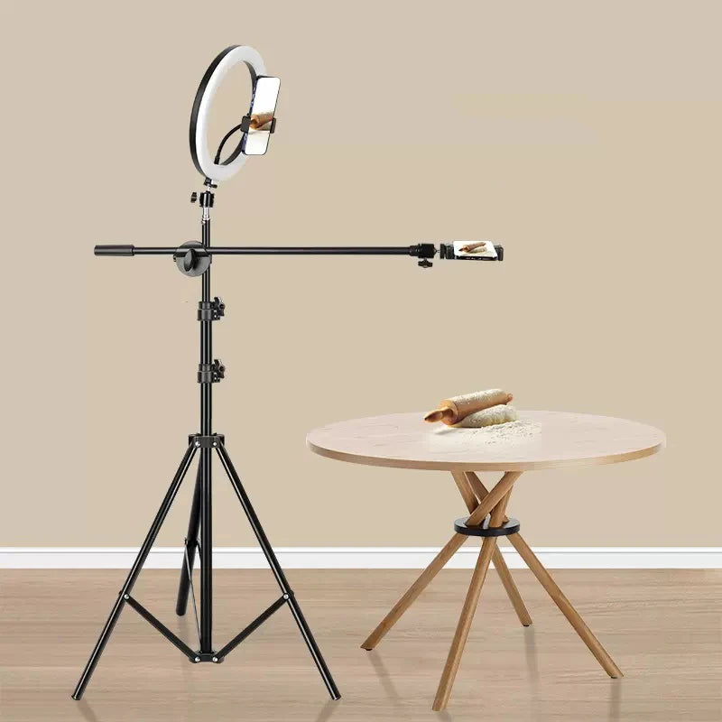 Black tripod stand with adjustable overhead arm, ring light, and phone mounts for overhead content creation.