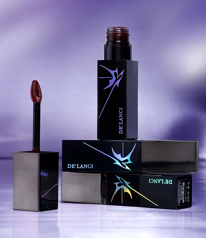 DE'LANCI gothic shimmer lip gloss with applicator, featuring dark moody packaging and high-pigment red lip mud texture.