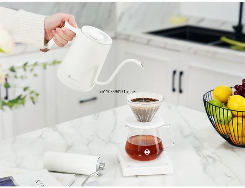 Timemore white gooseneck electric kettle pouring hot water over a glass pour-over coffee dripper on a digital scale.