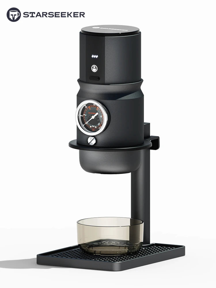 Starseeker matte black manual espresso maker with integrated pressure gauge and glass cup on a drip tray.