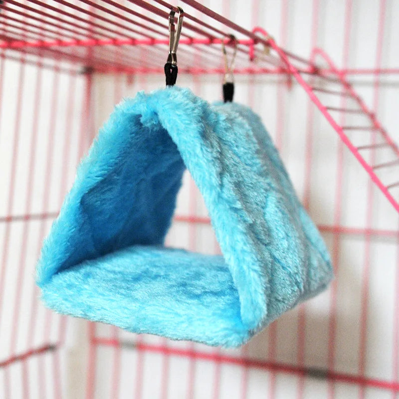 Blue plush hanging hammock bed for hamsters, birds, and small pets to keep them warm and cozy in their cage.