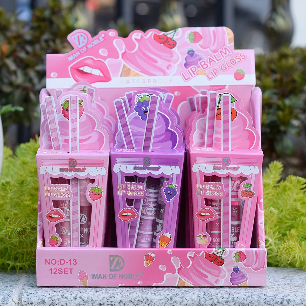 Cute ice cream-themed lip gloss and balm set in pink and purple display box with fruit illustrations.