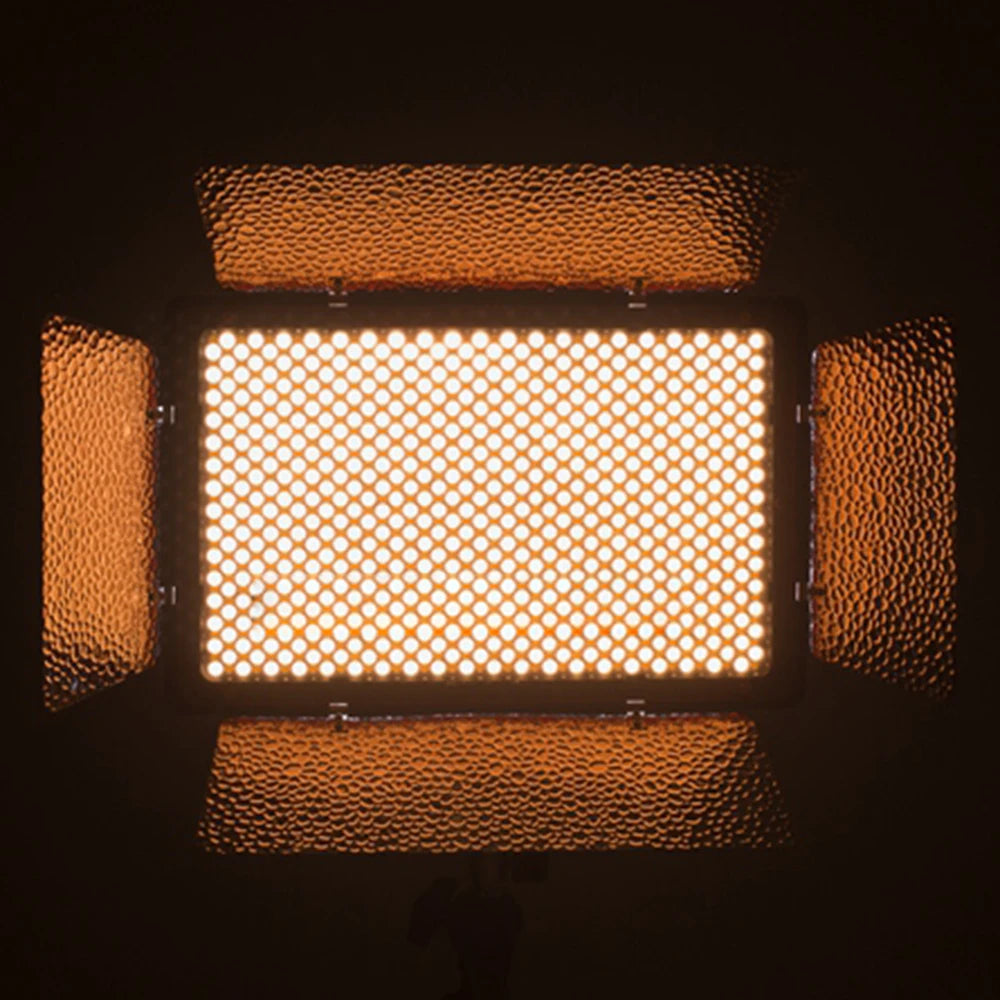 Rectangular LED video light with glowing diodes and four adjustable, hammered-texture metal barn doors.