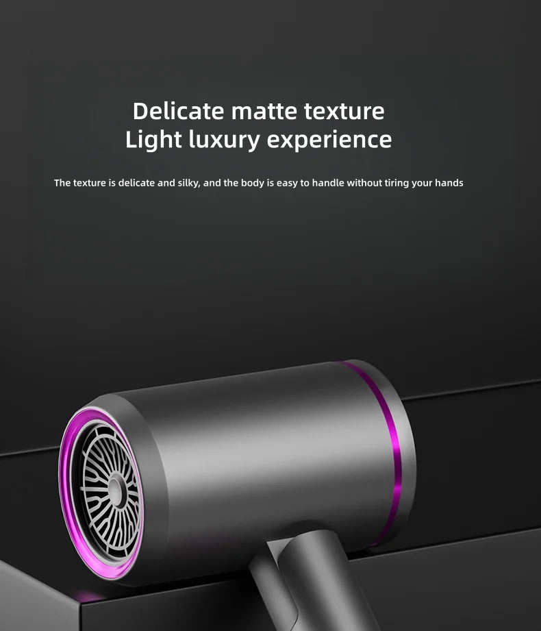 Matte gray foldable negative ion hair dryer with sleek purple accent ring for salon-quality high-speed hair drying.