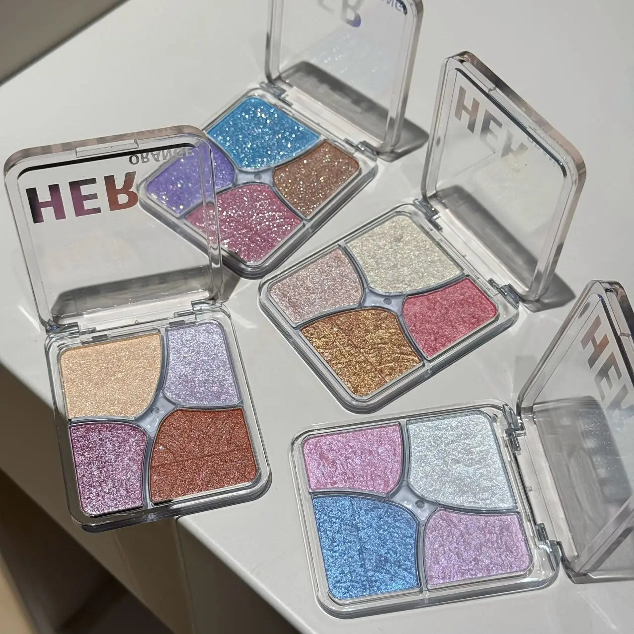 Tidesmit Herorange floral four-grid face makeup palette showing texture close-up of matte highlighter and blush