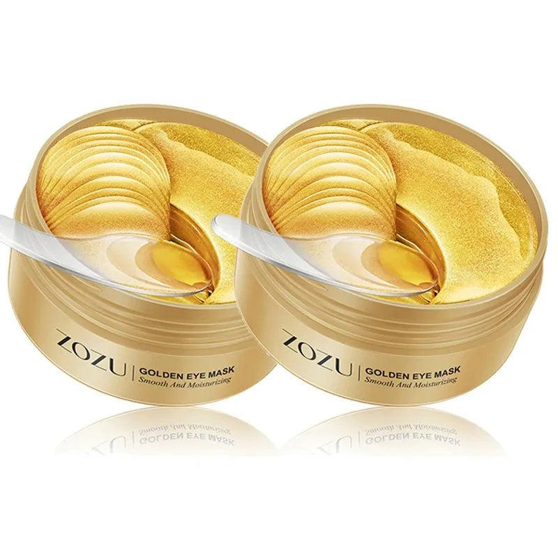 Two gold eye mask jars with applicator spoons, stacked gold gel layers