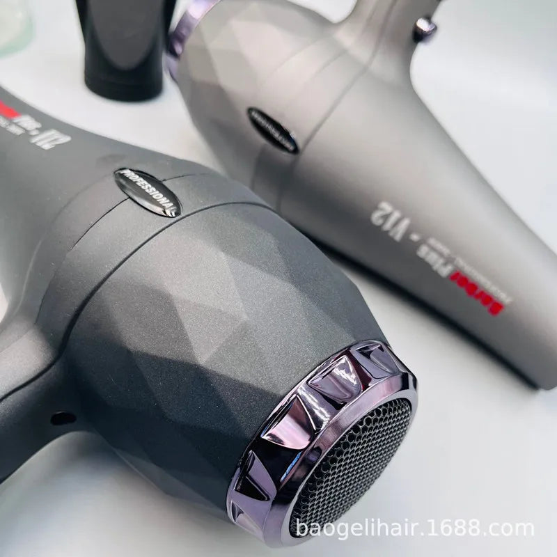 Professional 2600W salon hair dryer with faceted black/grey design, concentrator nozzle, and high-speed drying power.