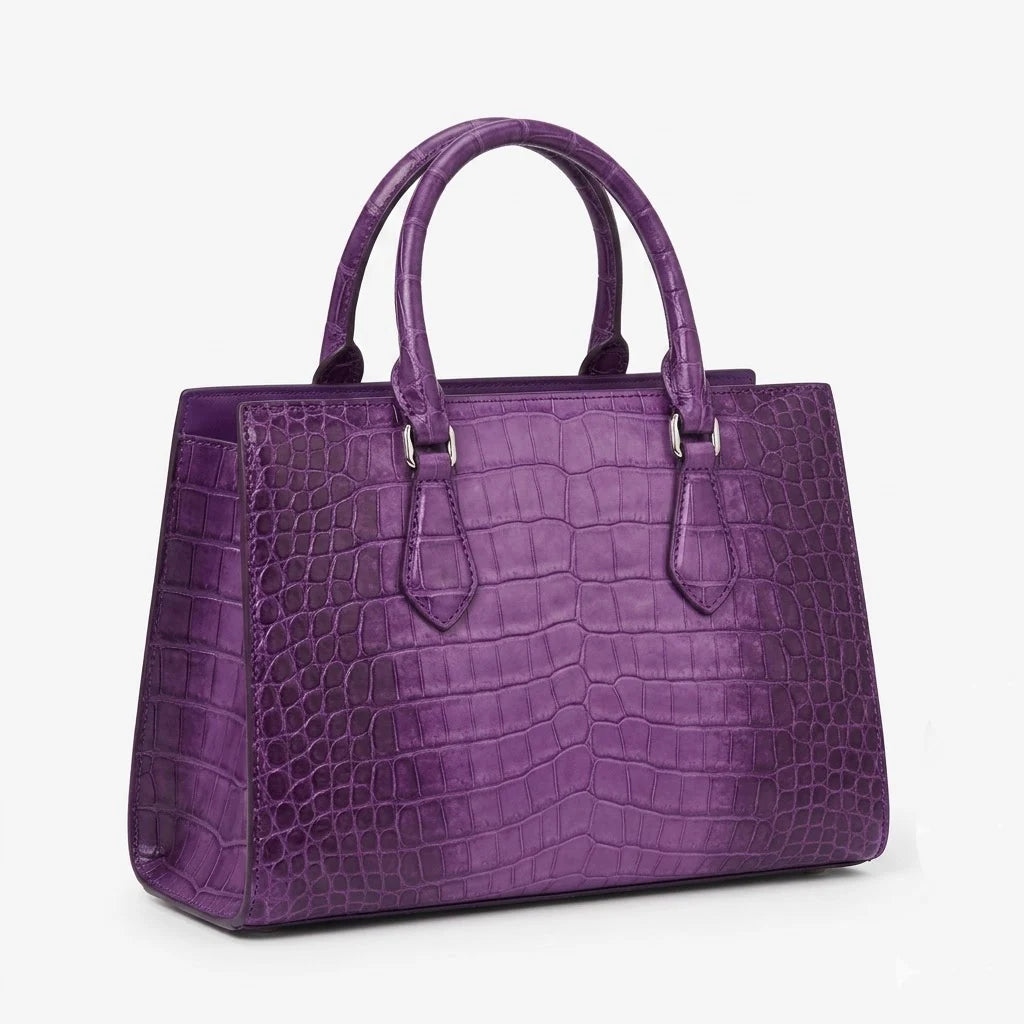 Purple genuine leather handbag with luxury alligator embossed pattern, top handles, and structured designer silhouette.