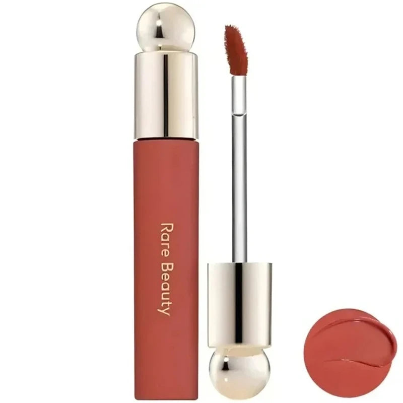 Rare Beauty Soft Pinch Tinted Lip Oil with applicator wand, featuring a smooth, moisturizing rosy-nude shade.