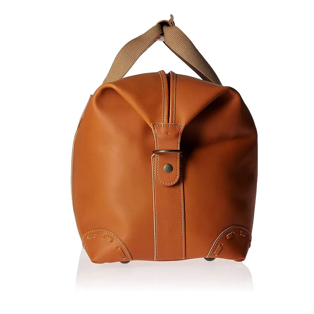 Tan PU leather travel trunk duffel bag with canvas handles, side shoe compartment, and vintage-style stitched corners.