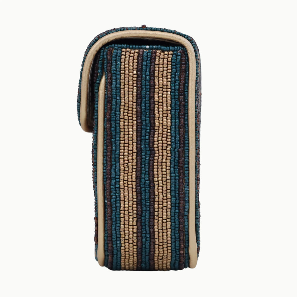 Bohemian designer shoulder bag, multi-color striped beaded flap, cream leather trim, vertical rectangular silhouette.