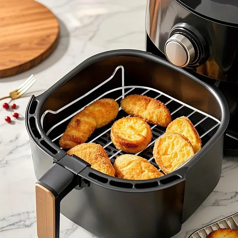 Air fryer grill rack holding breaded slices in the round air fryer basket