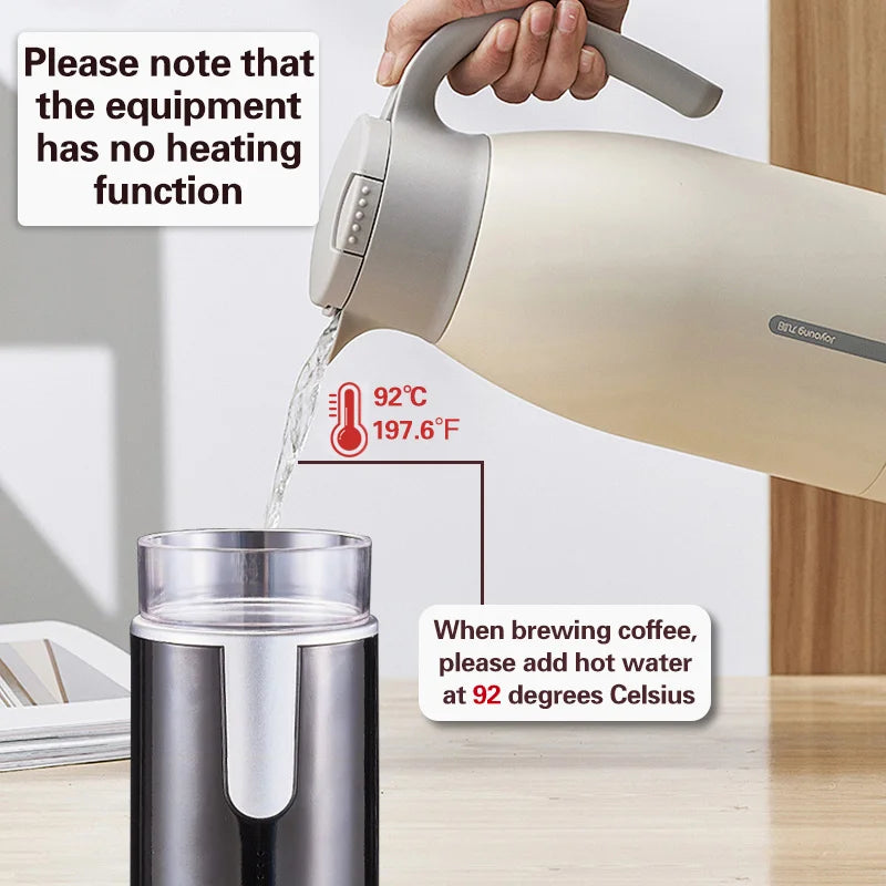 Joyoung non-heating thermal carafe pouring hot water into a portable coffee maker cup on a wooden table.