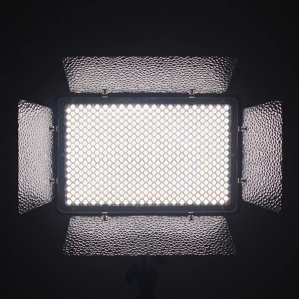 Rectangular LED video panel with four adjustable, silver hammered-metal barn doors, emitting bright white studio light.