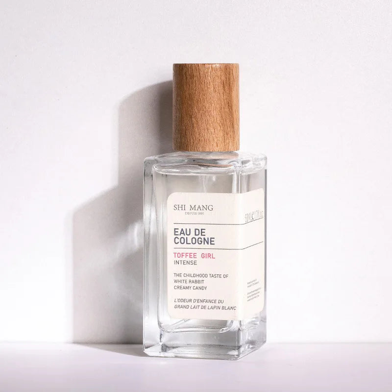 Shi Mang Toffee Girl EDP 50ml: Long-lasting woody fruity fragrance, square glass bottle with minimalist wood cap.