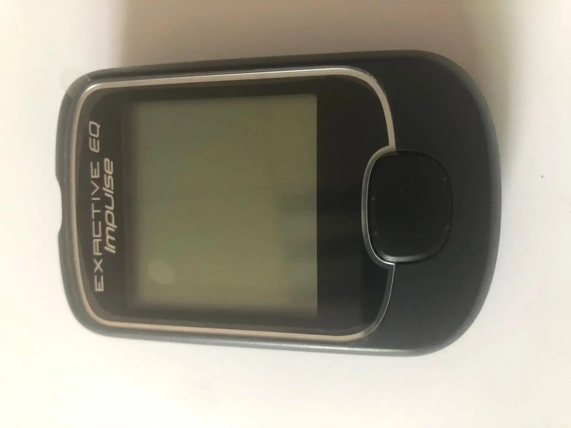 EXACTIVE EQ Impulse blood glucose monitor, compact black handheld diabetes meter with digital display screen.