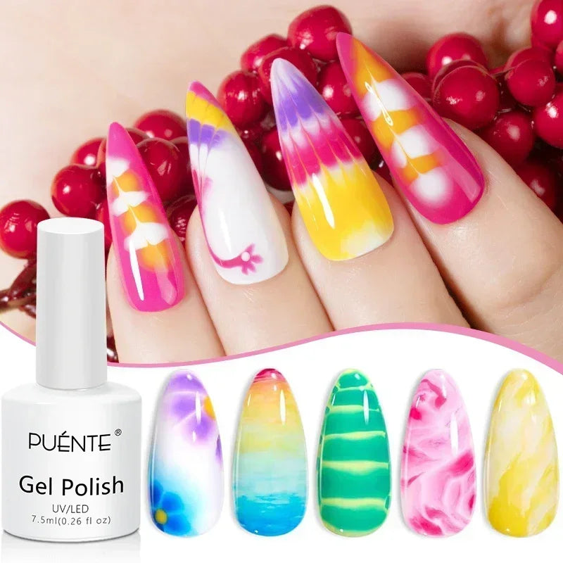Stiletto-shaped press-on nails with tie-dye, floral, and marble patterns in colorful UV gel polish.
