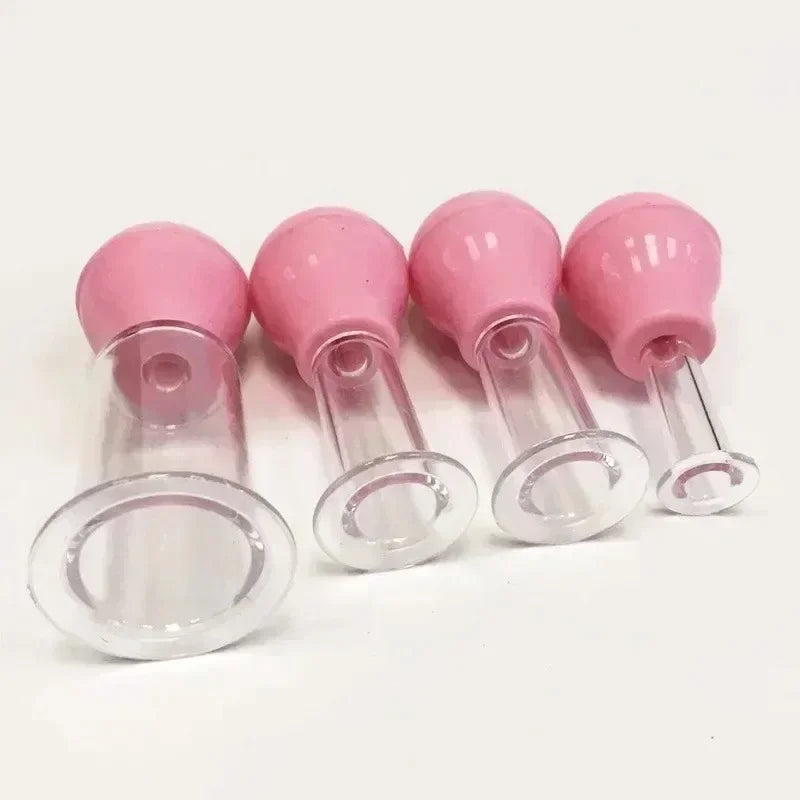 Four facial massage cupping tools with pink rubber bulbs and clear plastic suction heads in varying sizes.