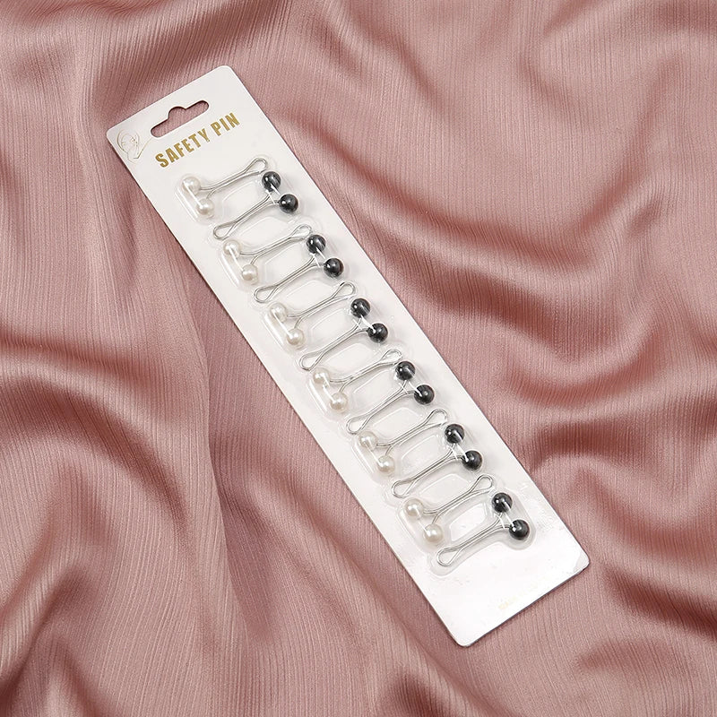Tidesmit 12-piece pack of silver U-shaped hijab safety pins with black and white pearl-like bead ends on a display card.
