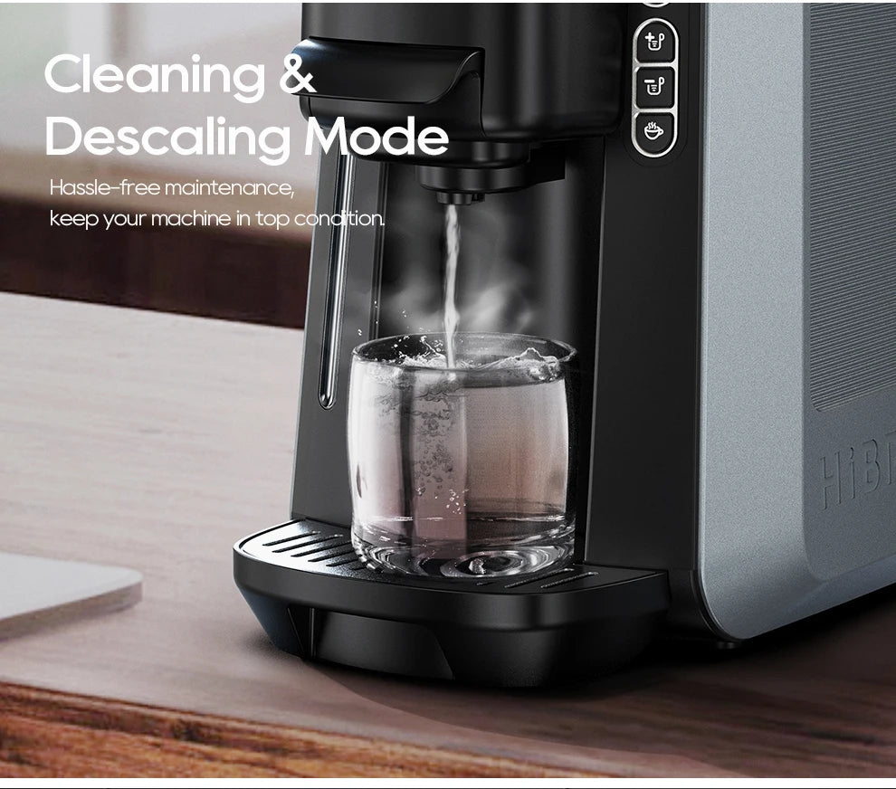 Hibrew coffee machine performing a cleaning and descaling cycle with hot water pouring into a clear glass cup.