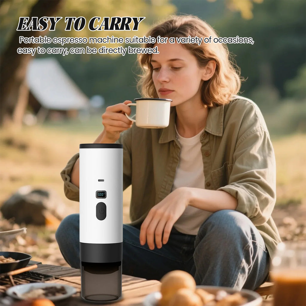 White portable espresso maker with digital display, used for camping by a woman drinking coffee.