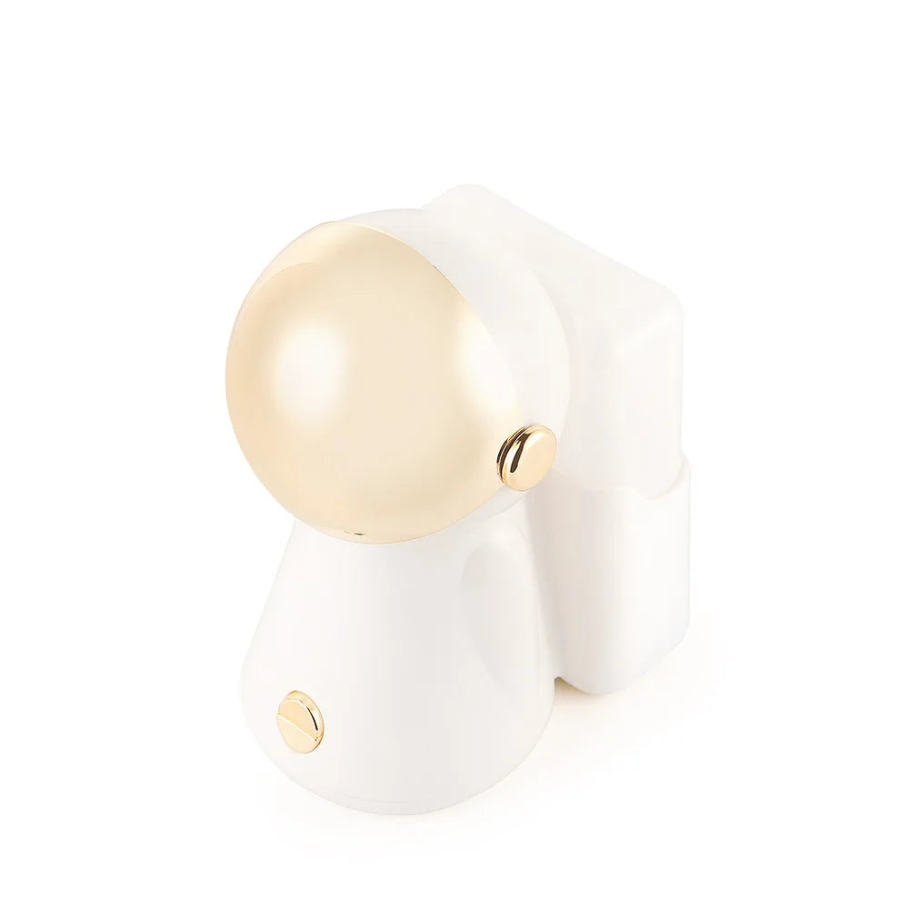 White and gold astronaut-shaped facial steamer and nano mist humidifier for pore cleansing and skin brightening.